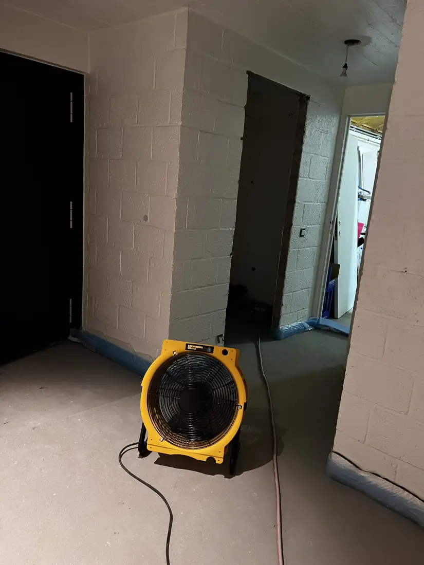 Krachtige ventilator stuwt de vochtige lucht door de gang in het ruwe metselwerk